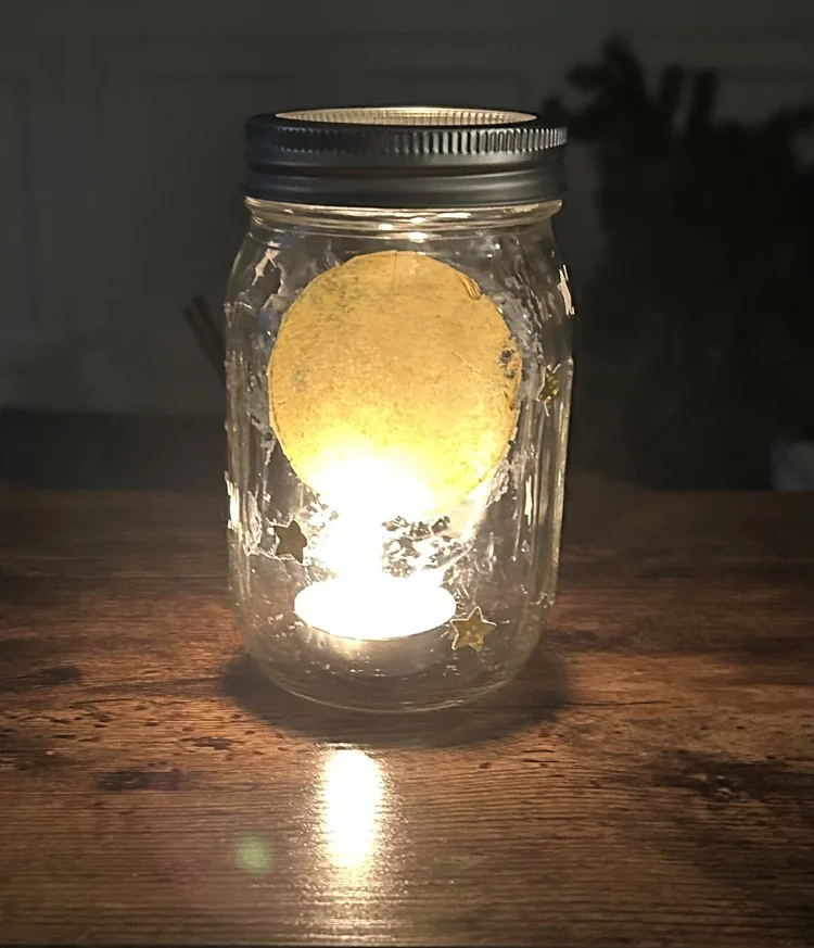 Two hands cradling a glass heart